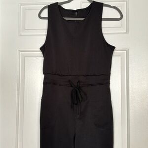 Black Jumpsuit Sleeveless, adjustable string at waist. Size Large, 29” length.